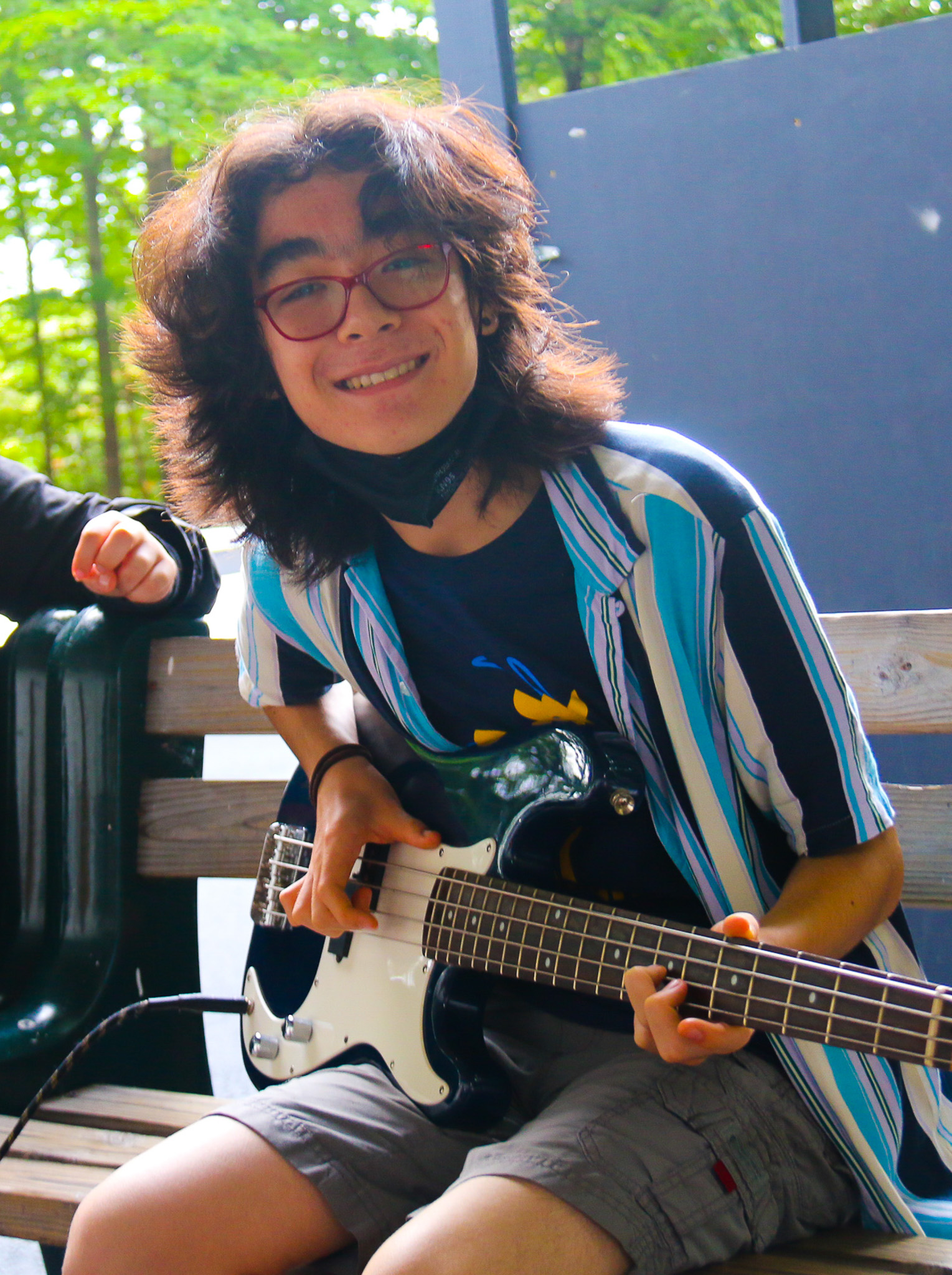 Camper playing a bass guitar