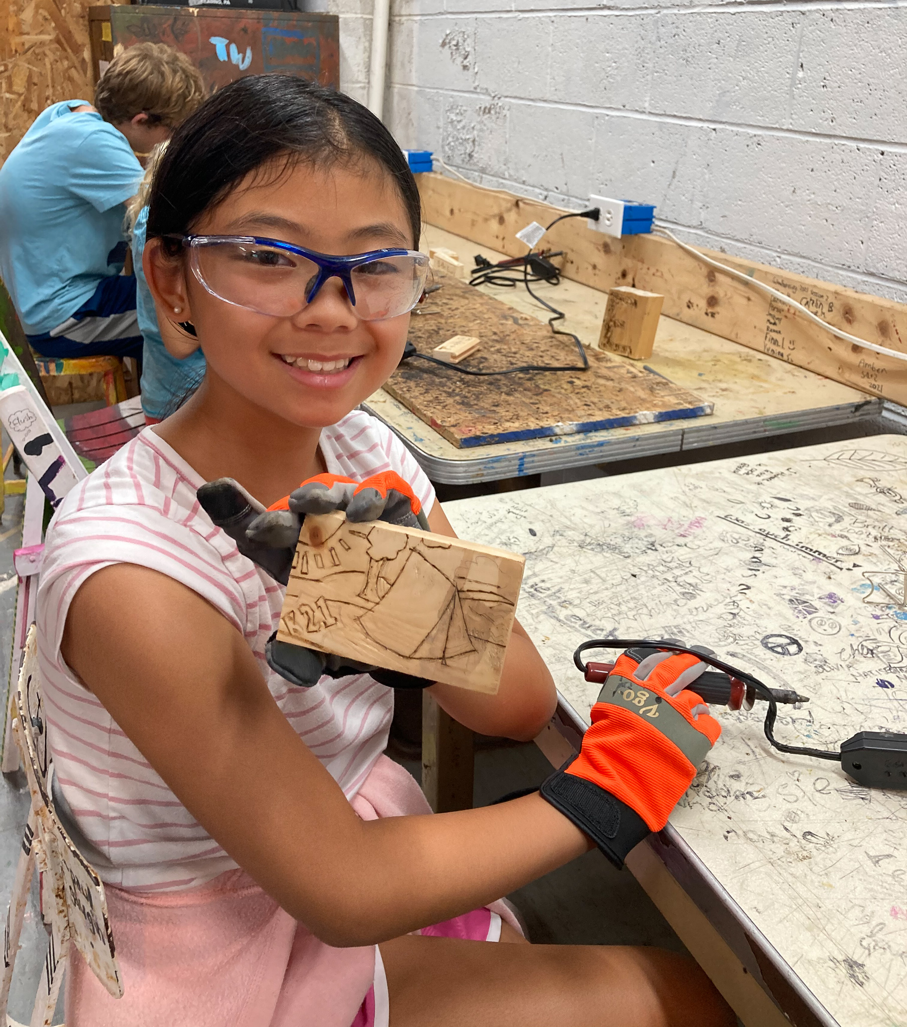 Camper with wood burning art