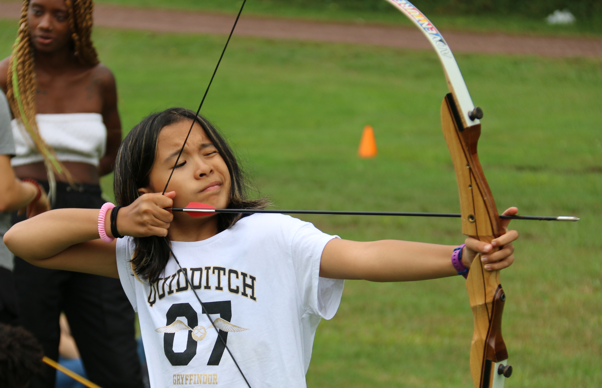 Camper shooting a bow and arrow