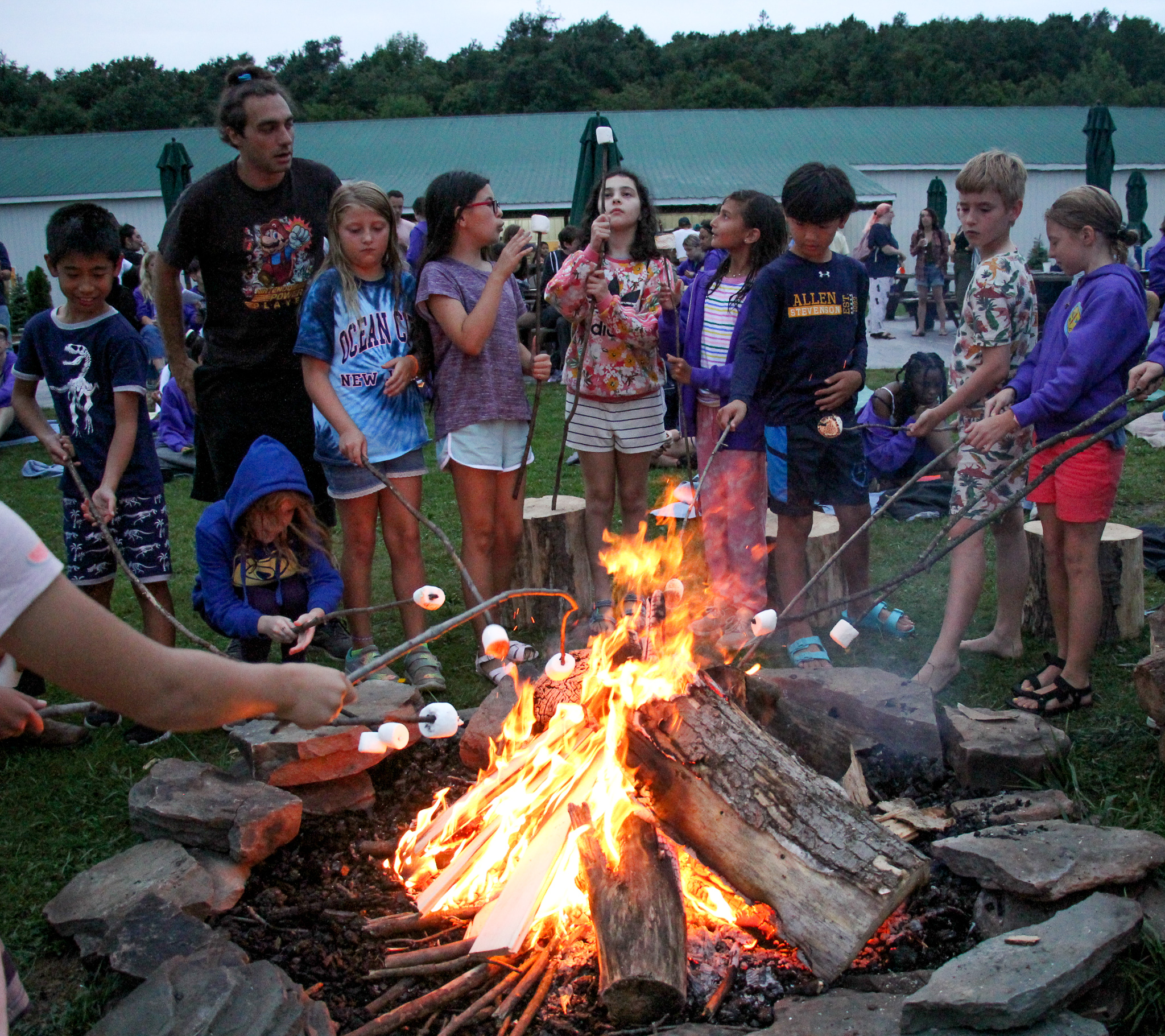Campers roasting marshmallows over a fire