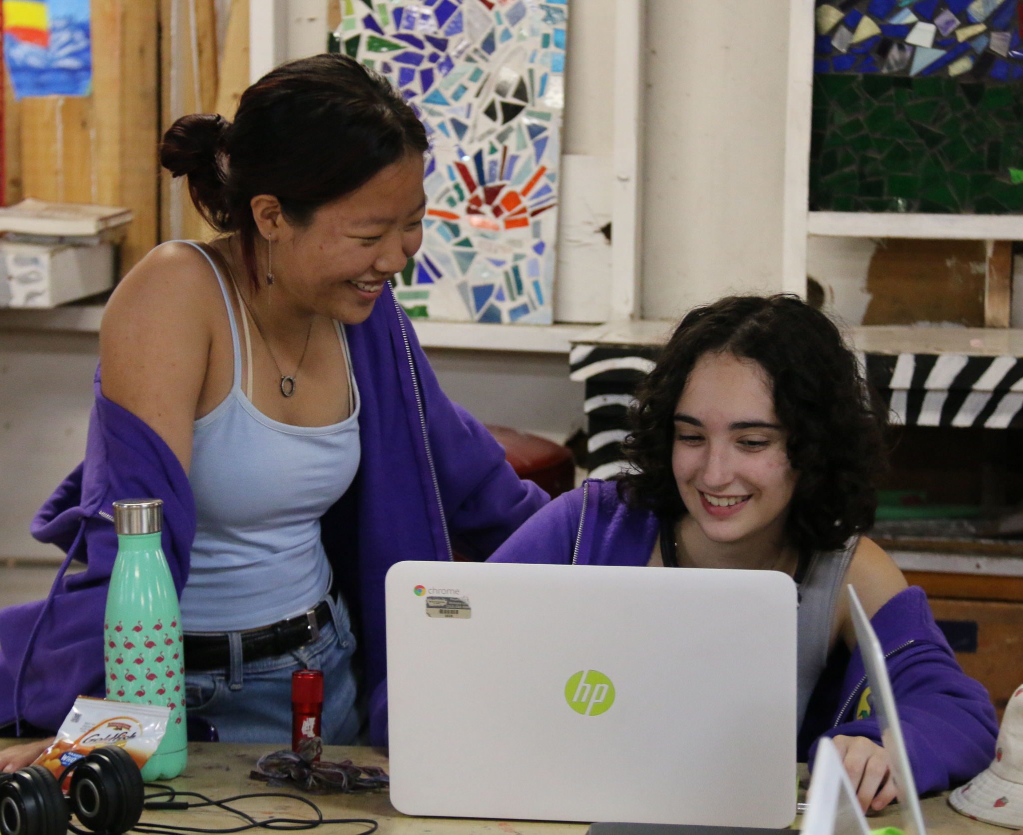 Two campers writing together in workshop
