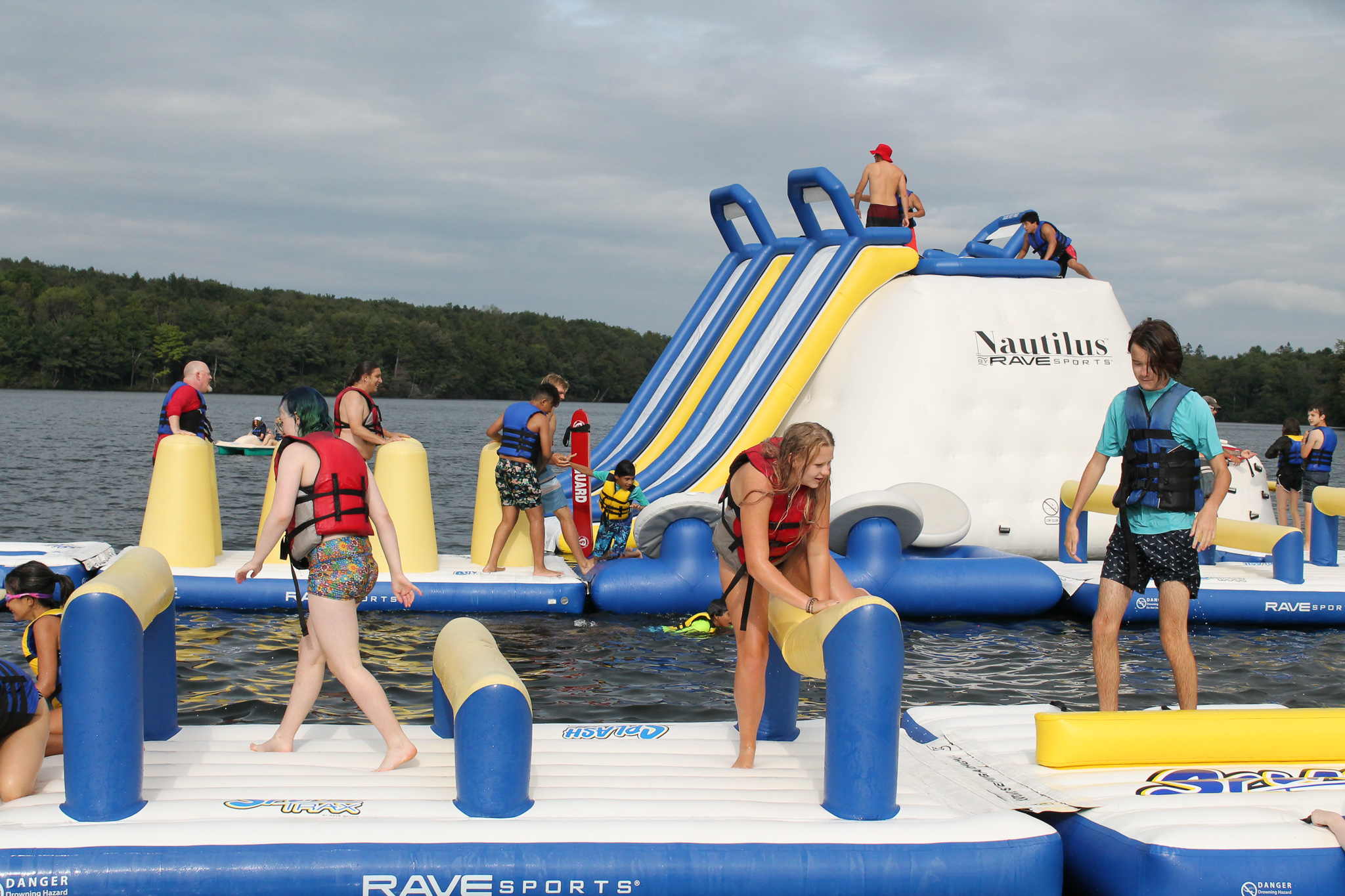 Campers climbing on inflatables in the lake