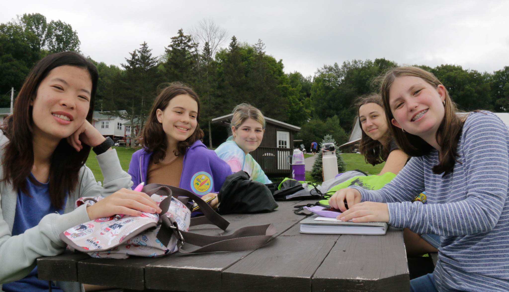 Campers sitting at a picnic table