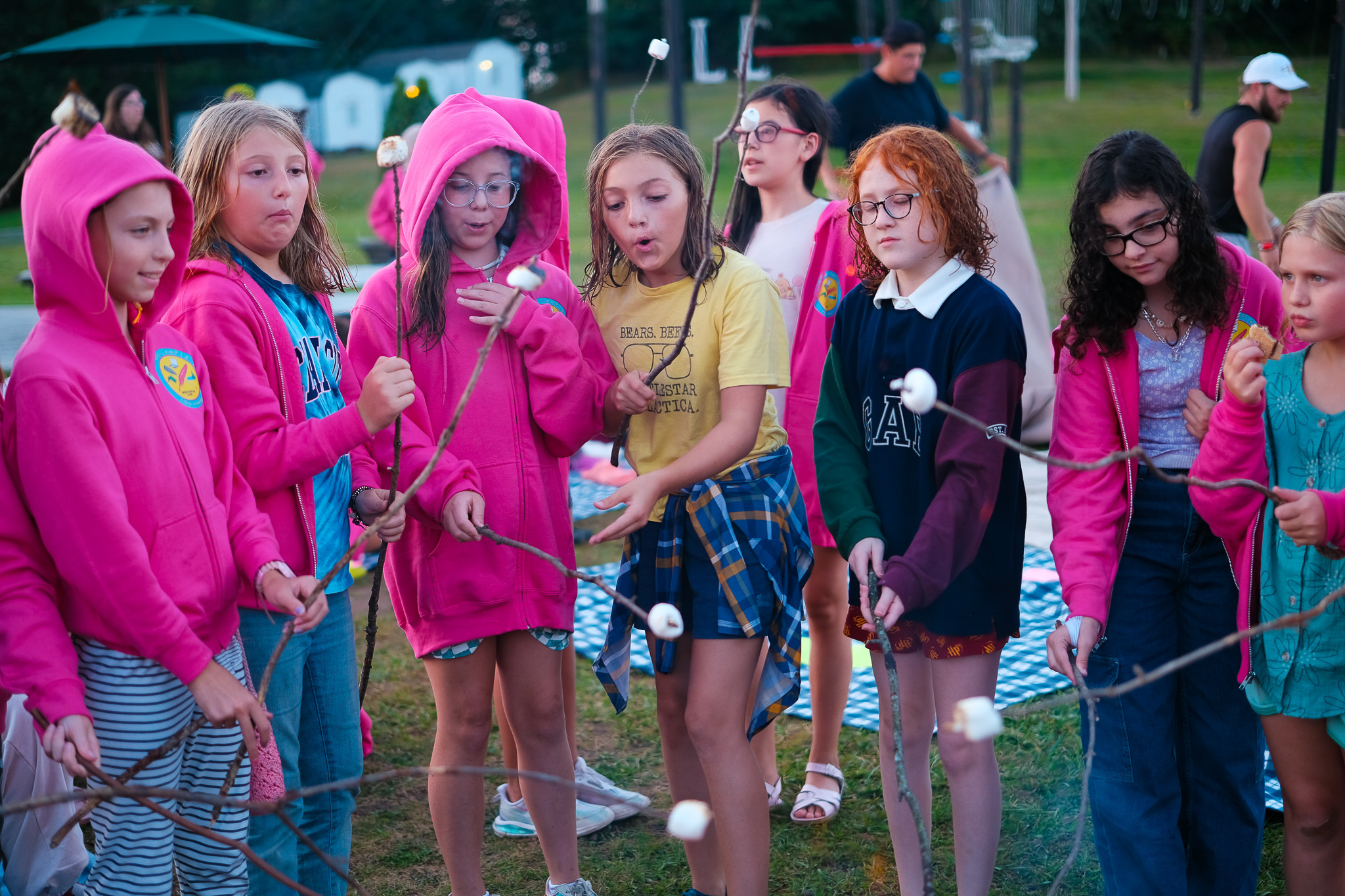 Campers roasting marshmallows over a campfire