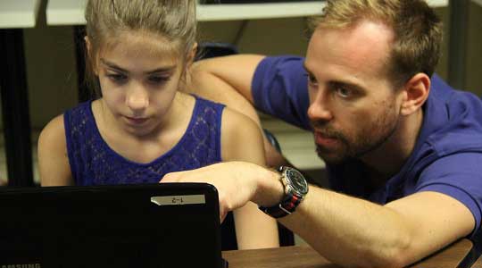 Instructor with young writer